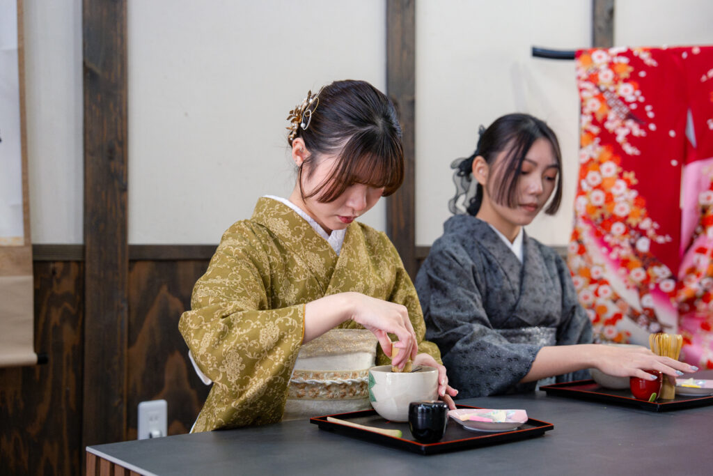 Whisking matcha with a bamboo whisk at TIA Chawanzaka